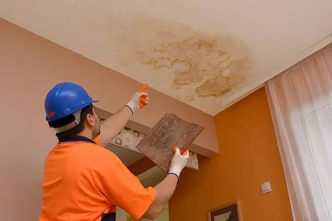 a technician is analyzing ceiling water damage